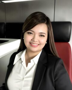 A woman in business attire sitting at the desk.